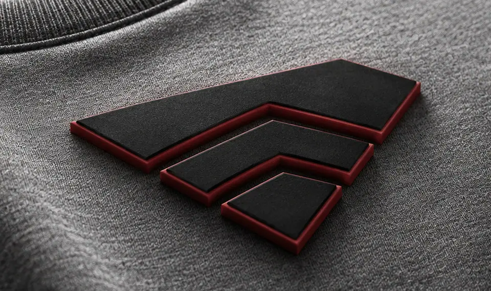 High density print standing proud of heather-grey jersey with sharp vertical walls and a contrasting red outline edge