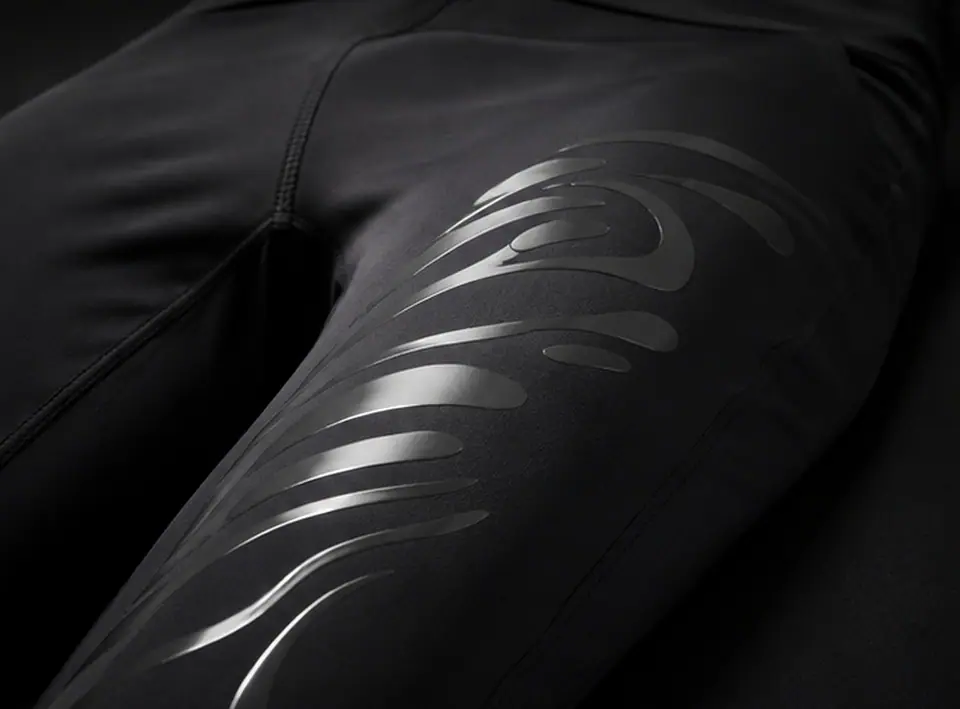 Tonal silicone graphic printed down the thigh panel of a black performance legging