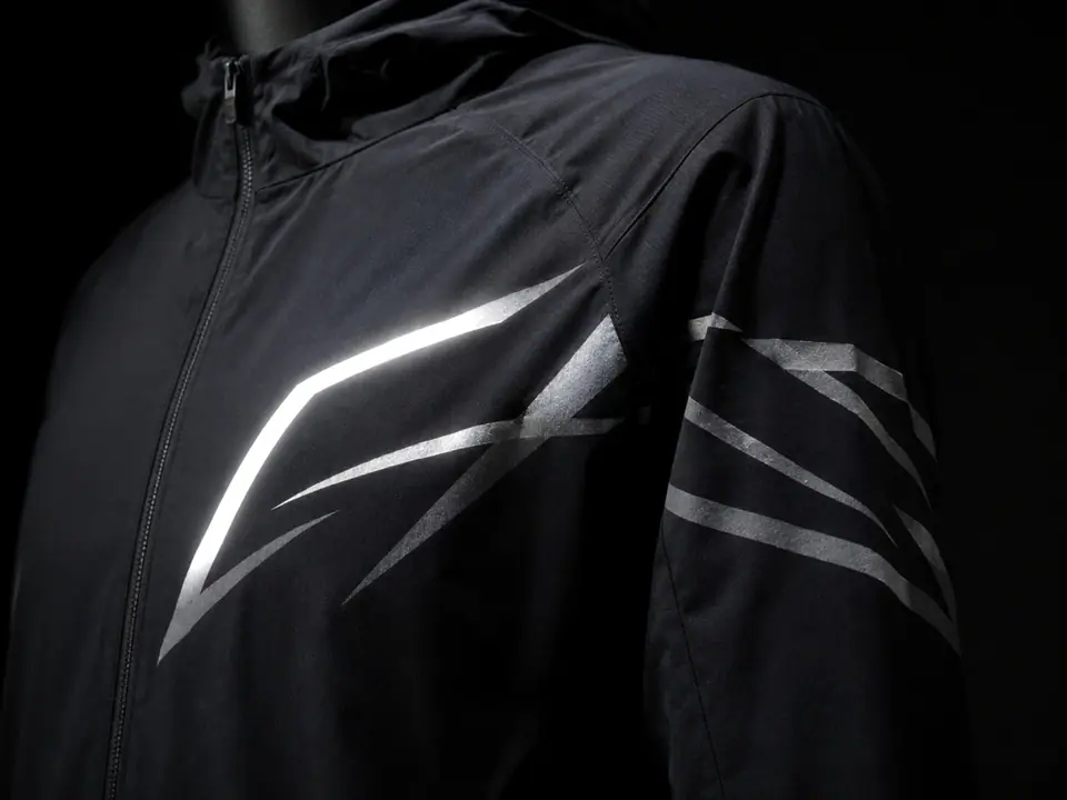 Retroreflective transfer flaring on a technical running jacket