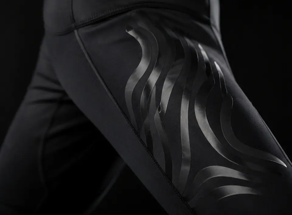 Close detail of a tonal silicone graphic on a dark performance panel