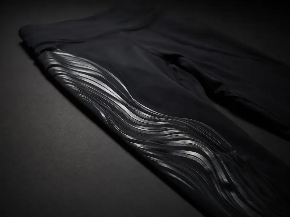 Flowing silicone bands printed along the leg of a black stretch legging
