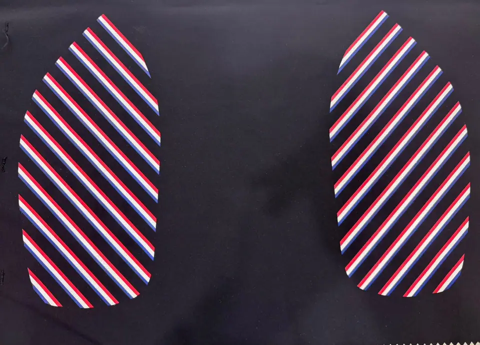 Striped silicone grip panels printed for footwear and apparel