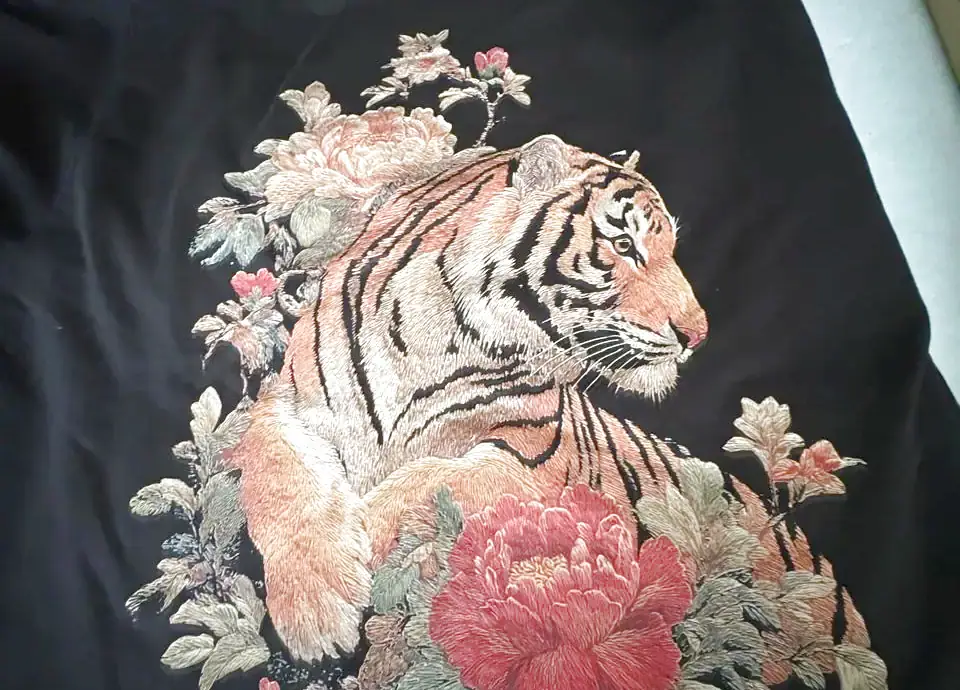 Velvet applique tiger and peony artwork on a black tee